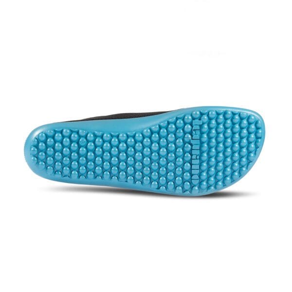 A sole view of the bottom of a pair of blue shoes.