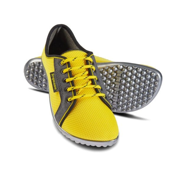 A pair of yellow shoes with grey soles.
