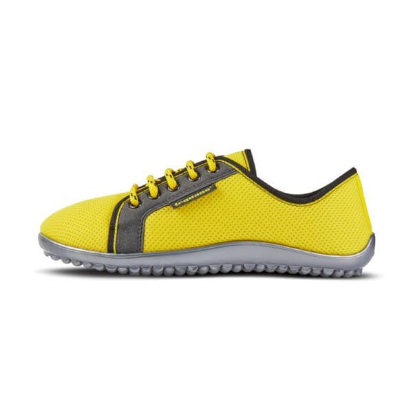 A yellow shoe with black and grey accents.