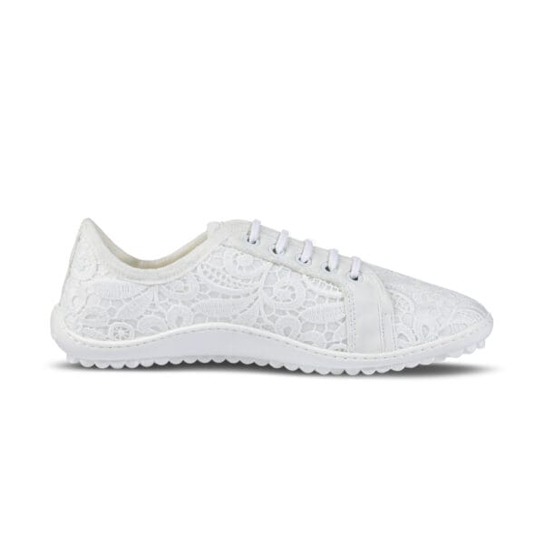 A white sneaker with a pattern on the side.