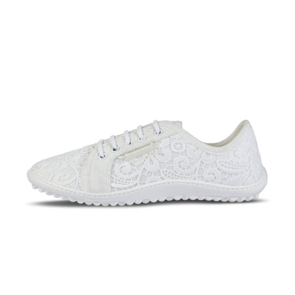 A white sneaker with a lace pattern on the side.