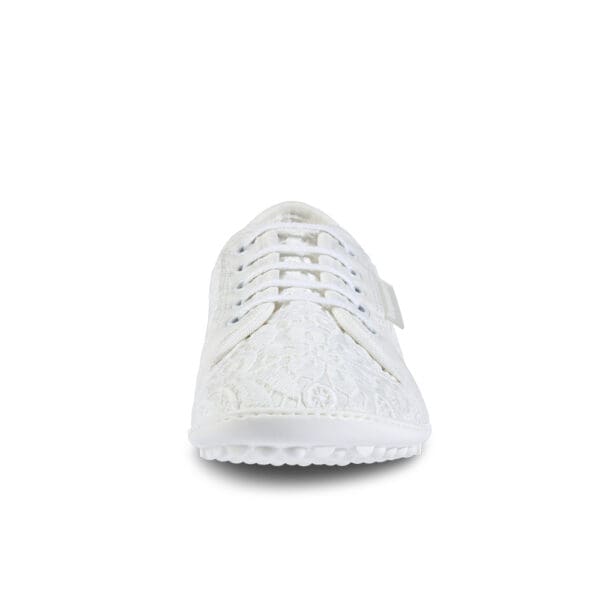 A white shoe with a lace up front.