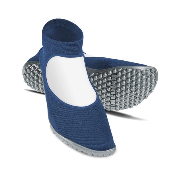 A pair of blue and white shoes with the sole in the air.