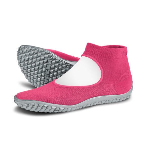 A pair of pink and white shoes with grey soles.