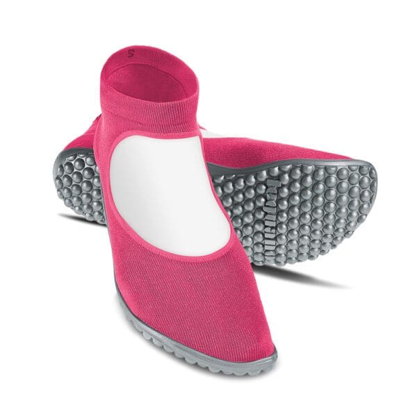 A pair of pink shoes with white soles.