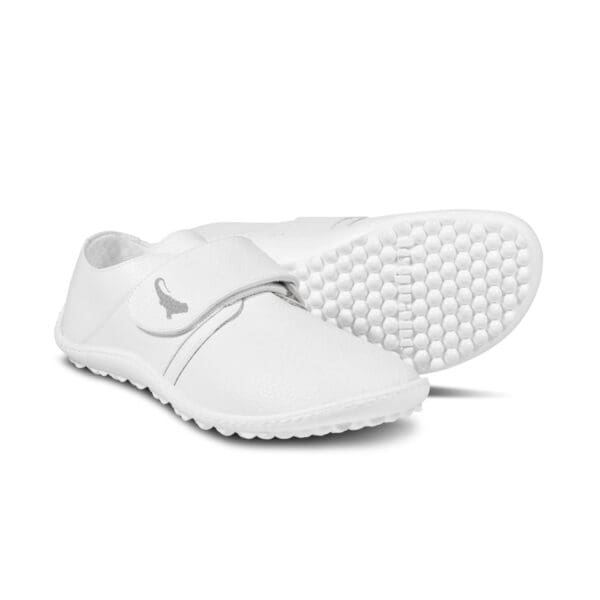 A pair of white shoes with velcro straps.
