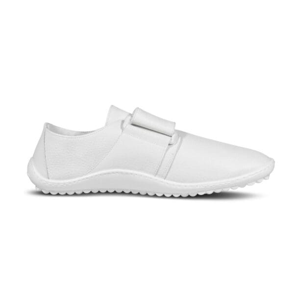 A white shoe with a strap around the top of it.