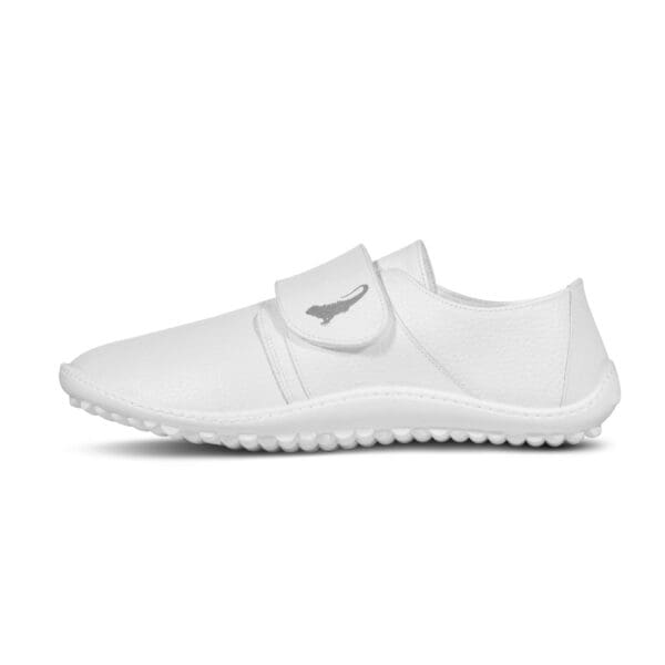 A white shoe with velcro strap on top of it.
