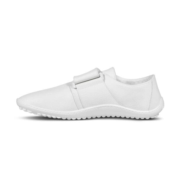 A white shoe with a strap around the top of it.