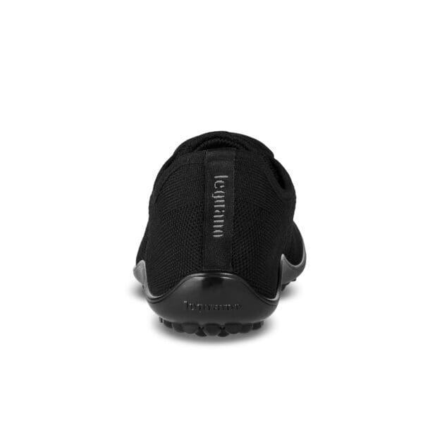 A back view of the bottom of a black sandal.