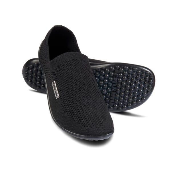 A pair of black shoes with a black sole.
