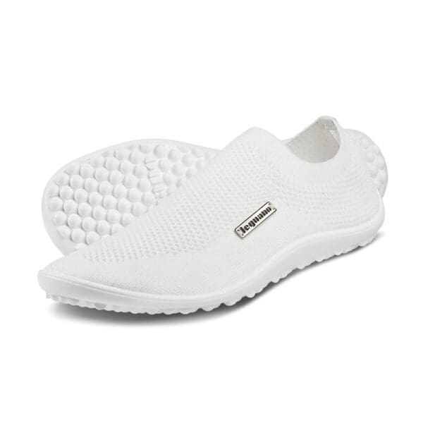A pair of white shoes with a rubber sole.