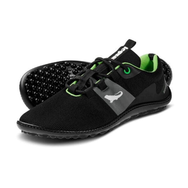 A pair of black shoes with green accents.